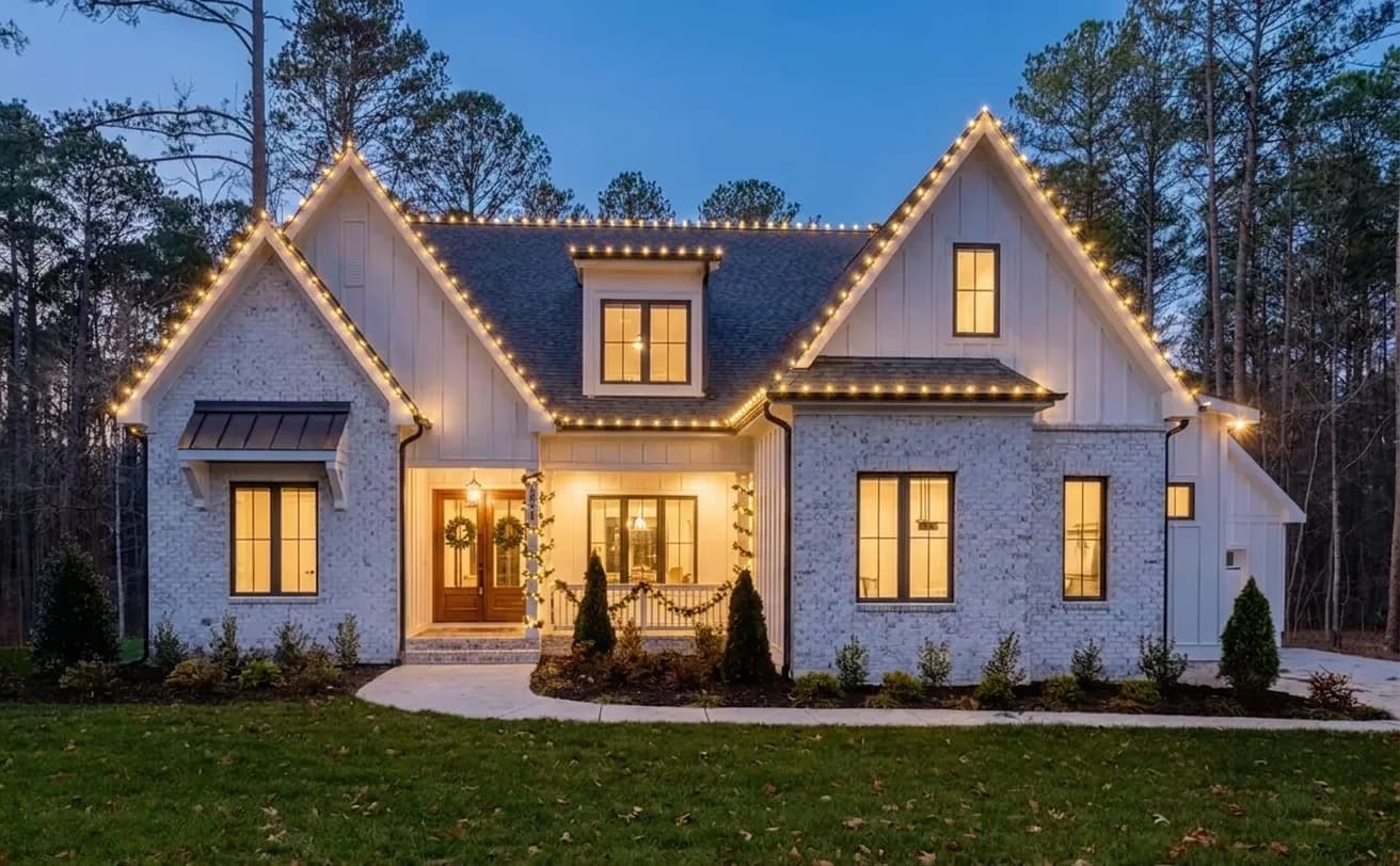 The same home rendered at dusk with professional warm white Christmas lights